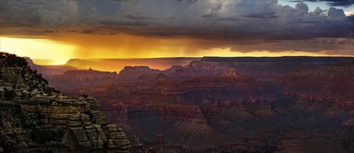 View of the Grand Canyon at sunset with storm clouds