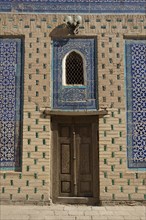Door and mosaic-decorated wall
