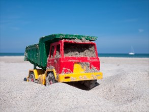 Toy dumper truck on a beach