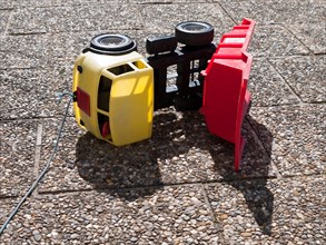 Toppled over toy dumper truck