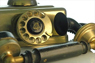 Old brass telephone with dial and handset