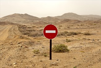 No entry' traffic sign in a desert landscape