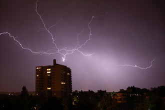 Lightning at night at a high-rise building