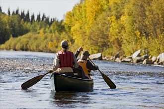 Men rowing a canoe