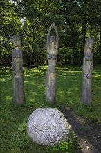 Wooden figures and a stone sculpture