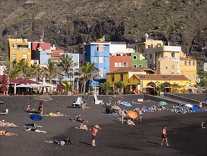 Tourists on the black beach of Puerto de Tazacorte