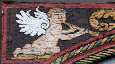 Angel with a flute on a half-timbered house