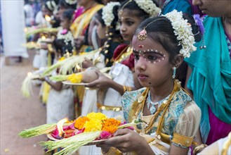 Girl offering flowers at a temple festival