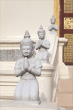 Kneeling statues adorn the Mondapa of Satra and Tripitaka