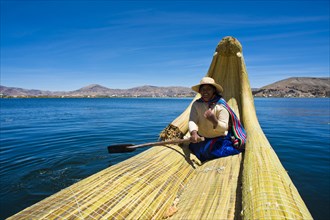 Local in a traditional rowing boat of Totora reed on Lake Titicaca