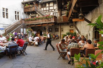 Courtyard of Schattenburg Castle with a restaurant