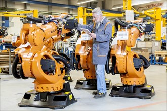 Employee of the robot manufacturer KUKA AG completing the shipping documents before delivery of KUKA robots