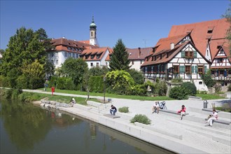 Promenade on the Neckar River with a half-timbered house and the former Carmelite monastery