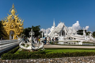 Ornate golend entrance of Wat Rong Khun