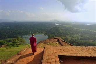 Buddhist nun enjoying the view from the ruins of the fortress on the Lion Rock
