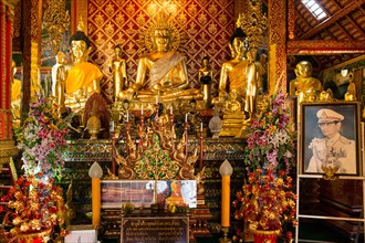 Golden Buddha statues and a picture of King Bhumibol Adulyadej in Wat Phrah Singh Temple