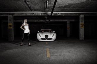 Woman standing next to a white sports car