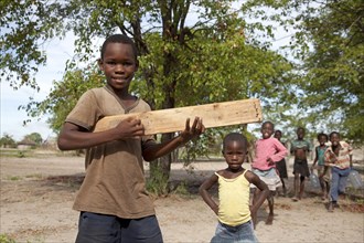 Children with a self-made toy guitar made of wood