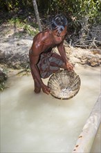 A labourer washing sand to win moonstones