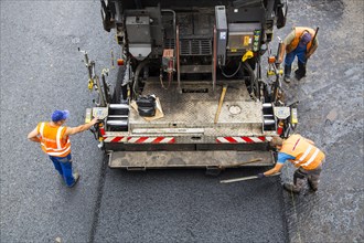 Tarmac laying machine at a road construction site
