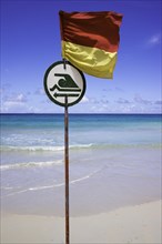 Dangerous beach with a flag indicating where bathing and swimming is possible