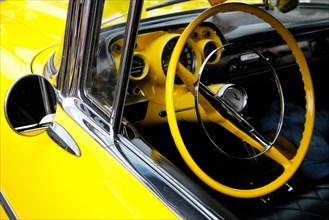 Detail of a Chevrolet Bel Air with yellow steering wheel and dashboard