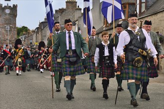 City dignitaries leading the parade of pipe bands