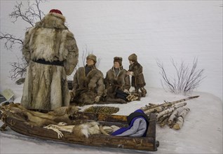 Sami family with a sled in winter