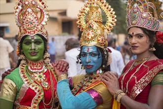 Hindu temple dancers wearing makeup and gold jewelry