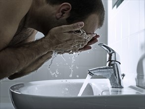 Man washing his face with both hands