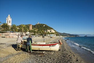 Fishermen with a fishing boat on the beach of Noli