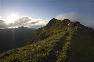 Hiker on the summit of Mt Grosser Galtenberg in the evening light