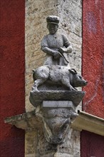 Sculpture of a butcher and pig at a butcher shop