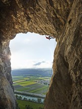 Sport climber climbing in a cave