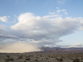 A sand storm over the Mesquite Flat Sand Dunes and the Amargosa Range in the evening