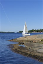 Sailboat and typical round polished rocks