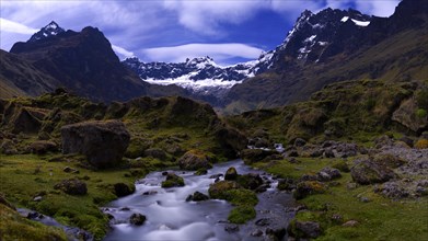 Mountain stream with the peaks of El Altar or Kapak Urku