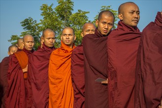 Buddhist monks collecting alms at the temple