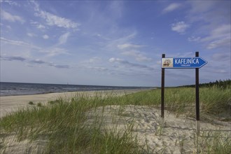 Sandy beach on the Baltic Sea with sign for a cafe