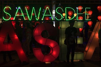 Sawasdee' lettering in neon lights
