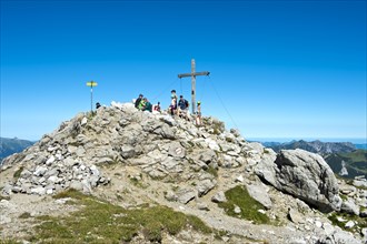 Rest at the summit cross on the Augstenberg mountain