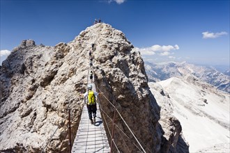Mountain climbers ascending Cristallino Mountain on the Via Ferrata Ivano Dibona climbing route on Monte Cristallo