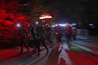 Runners wearing headlamps during a night run