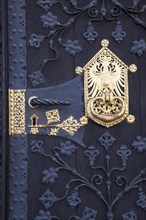 Door lock with a golden metal mount and the city coat of arms of Frankfurt