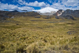 Snow-capped mountain peak rising over a high valley