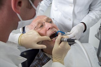 Senior man receiving treatment at the dentist