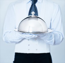 Waiter holding a cloche