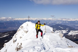Winter hiker on the summit ridge while descending from Weisshorn Mountain on Jochgrimm Pass
