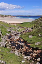 The Allt Chailgeag stream transporting brown bog water into Rispond Bay