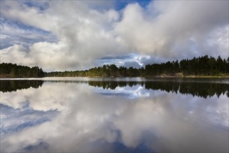 Stora Tresticklan Lake with dramatic clouds and mirroring